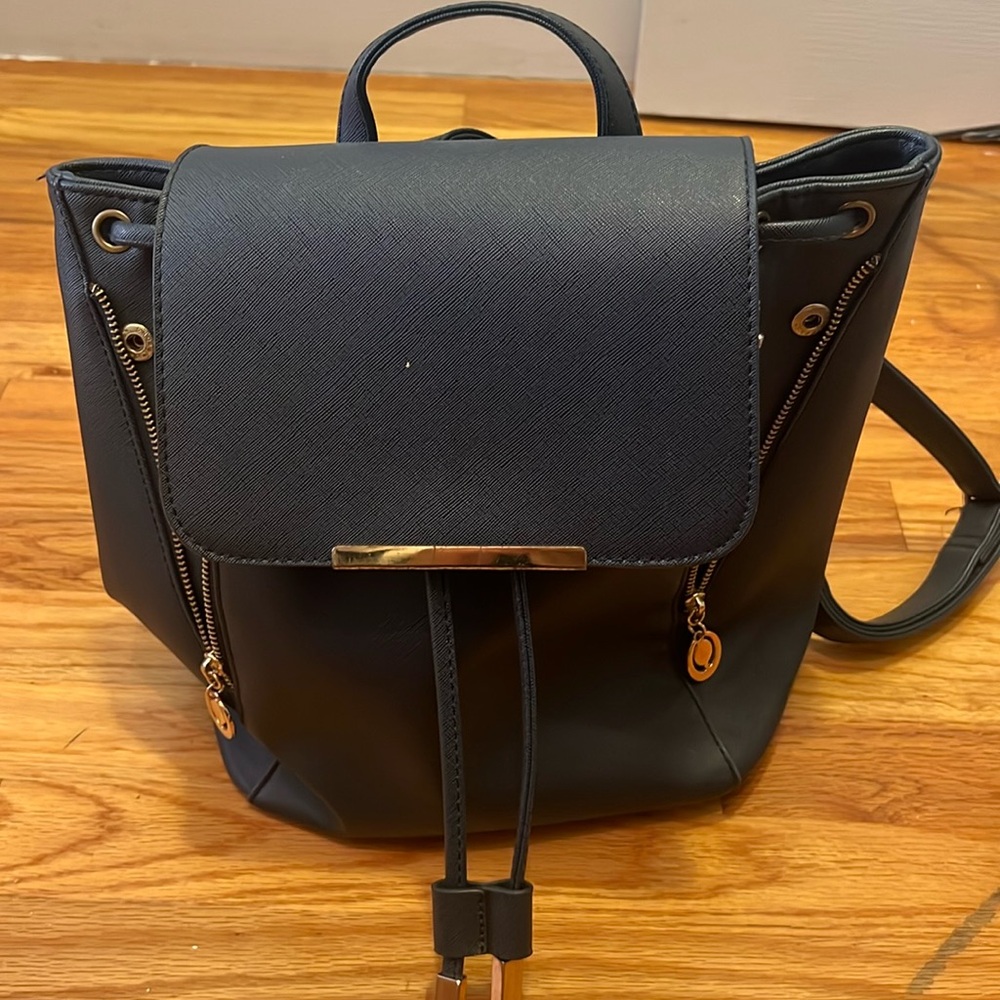 Stylish blue faux leather backpack with ample space for essentials!